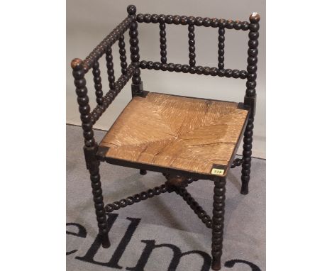 A 19th century ebonised bobbin turned corner hair, 58cm wide x 68cm high. 