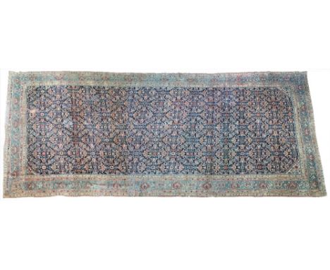 An unusual North West Persian Kelleh carpet, the dark indigo field with an allover herate design, minor small ivory spandrels