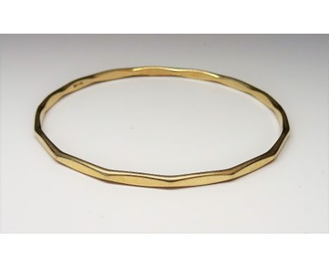 A 9ct gold circular bangle, having faceted decoration, internal diameter 6.5cm, weight 10.5 gms.