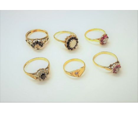 An 18ct gold, ruby and diamond set seven stone cluster ring, a 9ct gold, ruby and diamond set nine stone cluster ring, a 9ct 