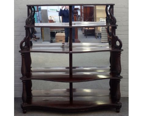 A 19th century Anglo-Portuguese mahogany mirror back display shelf, on five serpentine tiers, on spiral fluted baluster colum