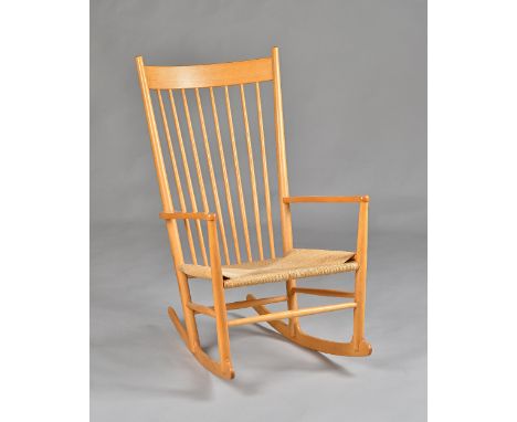 Moblier, Made in Denmark; a beech framed stick back rocking chair, 60cm wide x 108cm high. Illustrated. 