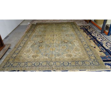 A Tabriz carpet, Persian the pale indigo field with a bold saffron medallion, ivory spandrels, all with palmettes and floral 