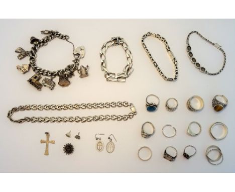 A group of mostly silver jewellery, comprising; a charm bracelet, three further bracelets, a necklace, a pendant cross and tw