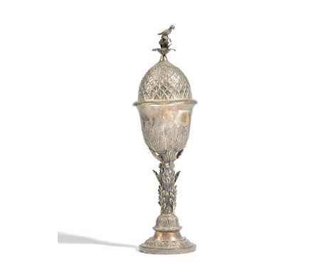 A foreign cup and cover, the stem of the cup decorated with leaves and acorns, raised on a circular foot, decorated with a fl