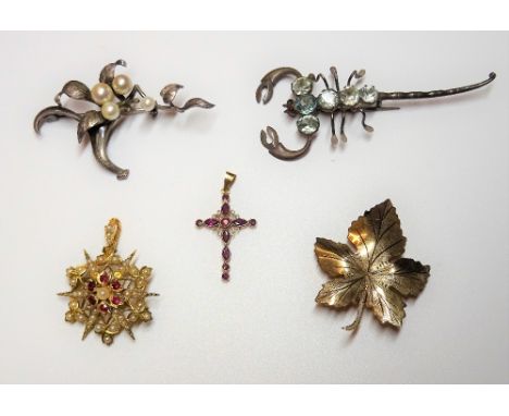 A gold, ruby and seed pearl pendant brooch, in a starburst and trefoil design, a 9ct gold brooch, designed as a leaf, a blue 