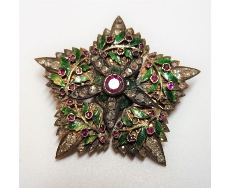 A gold, diamond, ruby set and green enamelled brooch, designed as a five pointed star and a green enamelled wreath, mounted w