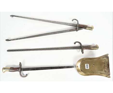 A set of three French bayonet fire tools, 19th century, each with wooden brass mounted handles, shovel 69cm, (3). 