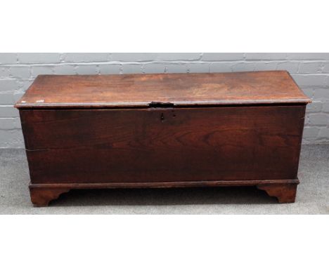 A 17th century elm plank coffer, on bracket feet, 128cm wide x 52cm high.