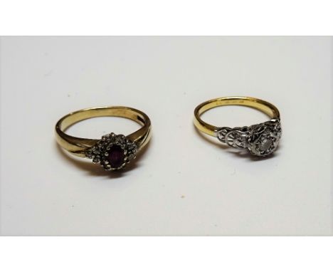 A gold and platinum, diamond set single stone ring, mounted with a circular cut diamond between decorated shoulders, detailed