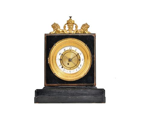 An Empire style ebonised mantel clock with twin gilt metal lion surmount and white enamel dial detailed 'Peter Pan in Wein', 