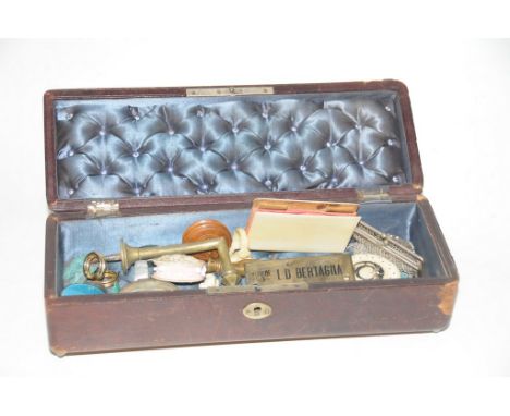 A Red leather hinged sewing box with white metal mounts and contents including Victorian ivory book cover, white metal link p