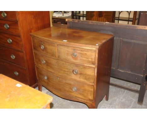 A 19th Century mahogany bow front chest of two short and two long drawers withbrass ring handles raised on outswept bracket f