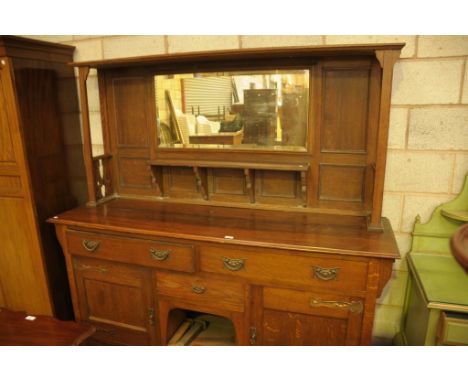 An Early 20th century oak arts and crafts mirror back back sideboard, the rectangular mirror plate above a shelf and a rectan