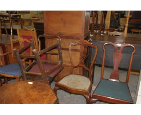 An 18th century style mahogany dining chair with a paper scroll crest and vase shaped splat, a second similar chair, an Edwar