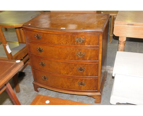 A Reproduction walnut bow front chest of four long drawers.