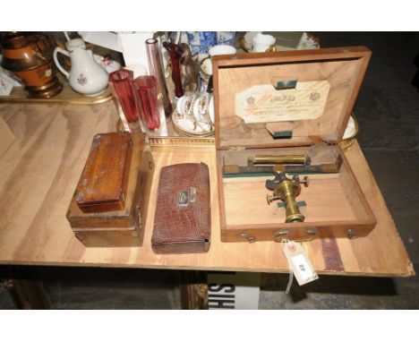 A French cased brass precision instrument, an early 20th century leather cased first aid kit , cased balance scales and weigh