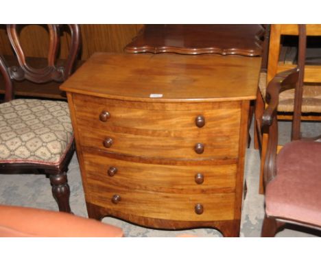 A 19th Century mahogany bow front commode chest with a hinged top and 4 faux drawers with turned handles.