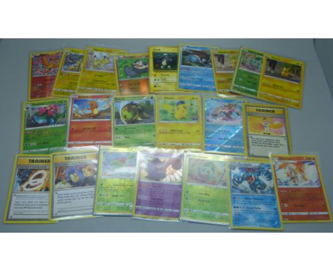 Twenty-two Pokemon cards including vintage, with holos of Pikachu, Bulbasaur, Ivysaur, Venusaur, Blastoise, etc., in protecti