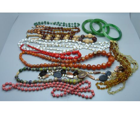A collection of vintage jewellery including three bangles and bead necklaces 