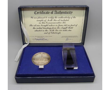 A 1975 commemorative set of North Sea Oil medallion and oil sample first landed 