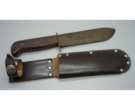 A military issue Bowie knife, J.R. 1979 127/6214 and broad arrow stamped on the blade, with leather scabbard