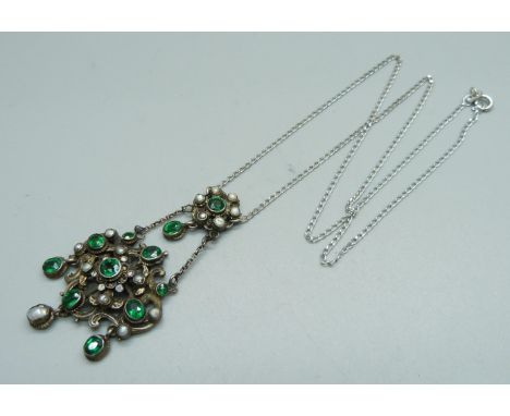 A vintage pearl and green stone set necklet on a modern silver chain 