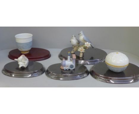 Three boxed Lladro figures:- Train, First Christmas, Natures Duet, and two others, with stands 