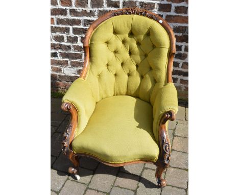 Ornately carved walnut Victorian button back arm chair