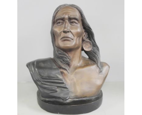 A polychrome bronze bust of a Native American on a black marble base, signed F Remington