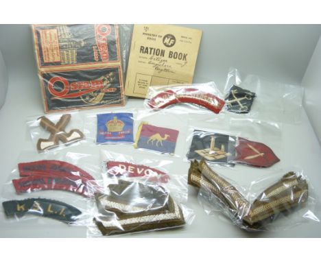 A collection of military badges including a British Commonwealth Force Formation sign, Royal Leicestershire Regiment cloth, a
