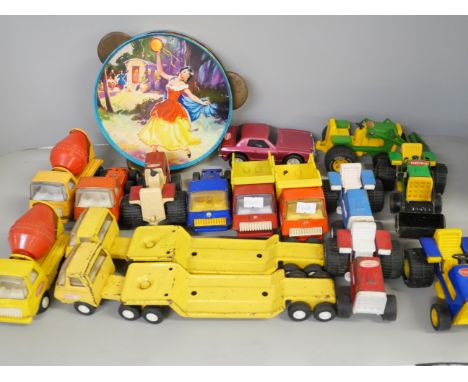 A collection of Tonka cars dating from 1950's, a tambourine and a rotating aircraft ride