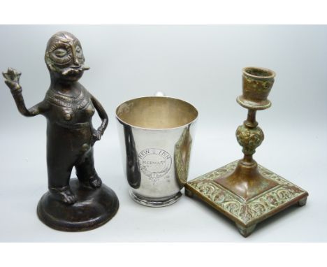 A South East Asian cast bronze fertility figure, plated mug and a bronze candlestick