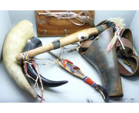 Two horns, a child's cap gun in leather holster, a spear, etc.