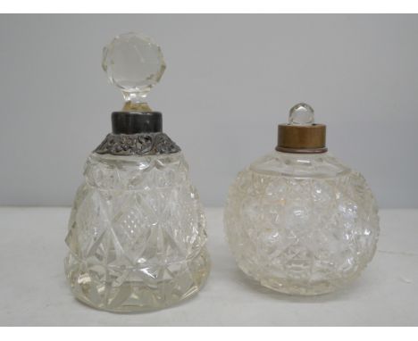 Two glass perfume bottles, one with silver collar, loose and stopper stuck, the other with stopper but lacking top