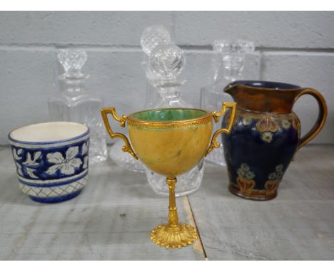 A Royal Doulton jug, a gilt metal two handled urn, four glass decanters and a planter **PLEASE NOTE THIS LOT IS NOT ELIGIBLE 