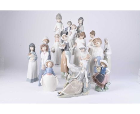 A collection of Lladro and Nao figures, late 20th/early 21st century, including a woman in a shawl holding a rabbit, ballerin