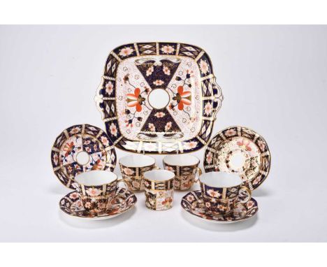 A Royal Crown Derby imari part tea service, pattern 2451, comprising thirteen teacups, eleven saucers, one cake or bread and 