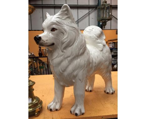 A LARGE WHITE CERAMIC SAMOYED DOG 