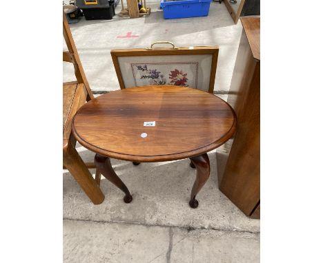 AN OVAL WALNUT OCCASIONAL TABLE AND FIRESCREEN 