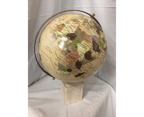 A LARGE GLOBE ON A WOODEN BASE 