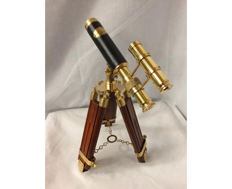 A BRASS AND LEATHER TELESCOPE ON A WOODEN TRIPOD STAND, 34CM HIGH 