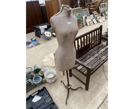 A FEMALE MANNEQUIN WITH A HEAVY METAL BASE 