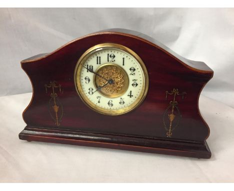 AN INLAID MAHOGANY MANTLE CLOCK WITH GILDED CENTRE FACE AND ENAMEL DIAL 