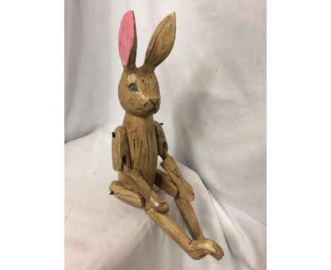 A WOODEN SHELF PUPPET RABBIT 