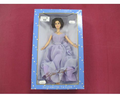 A Boxed Mattel 2000 Elizabeth Taylor Doll/White Diamonds; with accesories and stand, minor wear and tear to box noted, 28076.