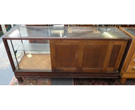 A shop display cabinet, 184 x 60 x 90 cm, glazed all around apart from the sliding rear doors to the back, the interior with 