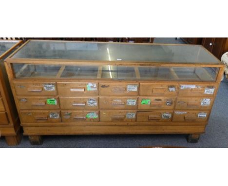 A shop display cabinet, 181 x 58 x 91 cm, glazed to three sides, the interior comprises a single glass top shelf accessed thr