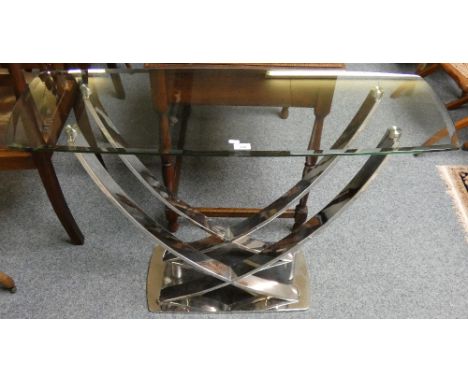 A glass topped console table on chromed base