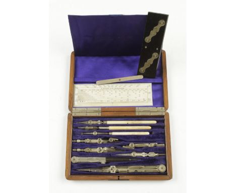 A small drawing set with ivory scale rule by HALDEN and an ebony parallel rule in beautifully figured mahogany box G+